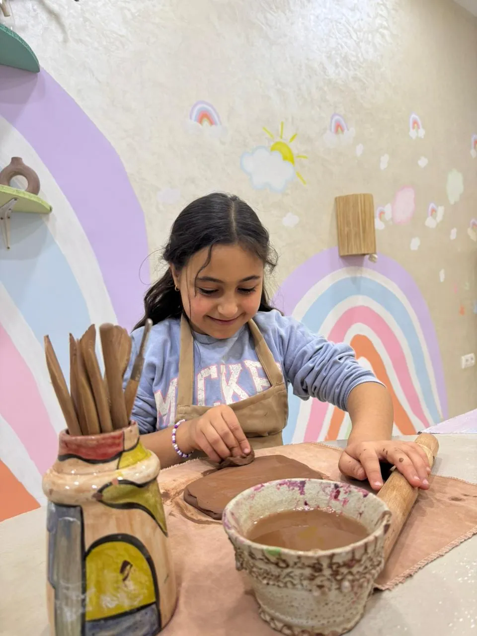 Child shaping Moroccan clay at the Live It Maghribi kids pottery atelier in Agadir